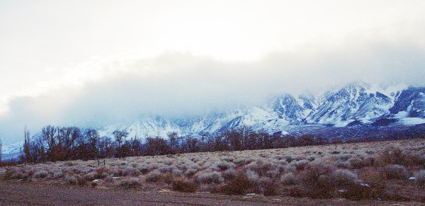 Clouds Falling Over Snowy Mountains